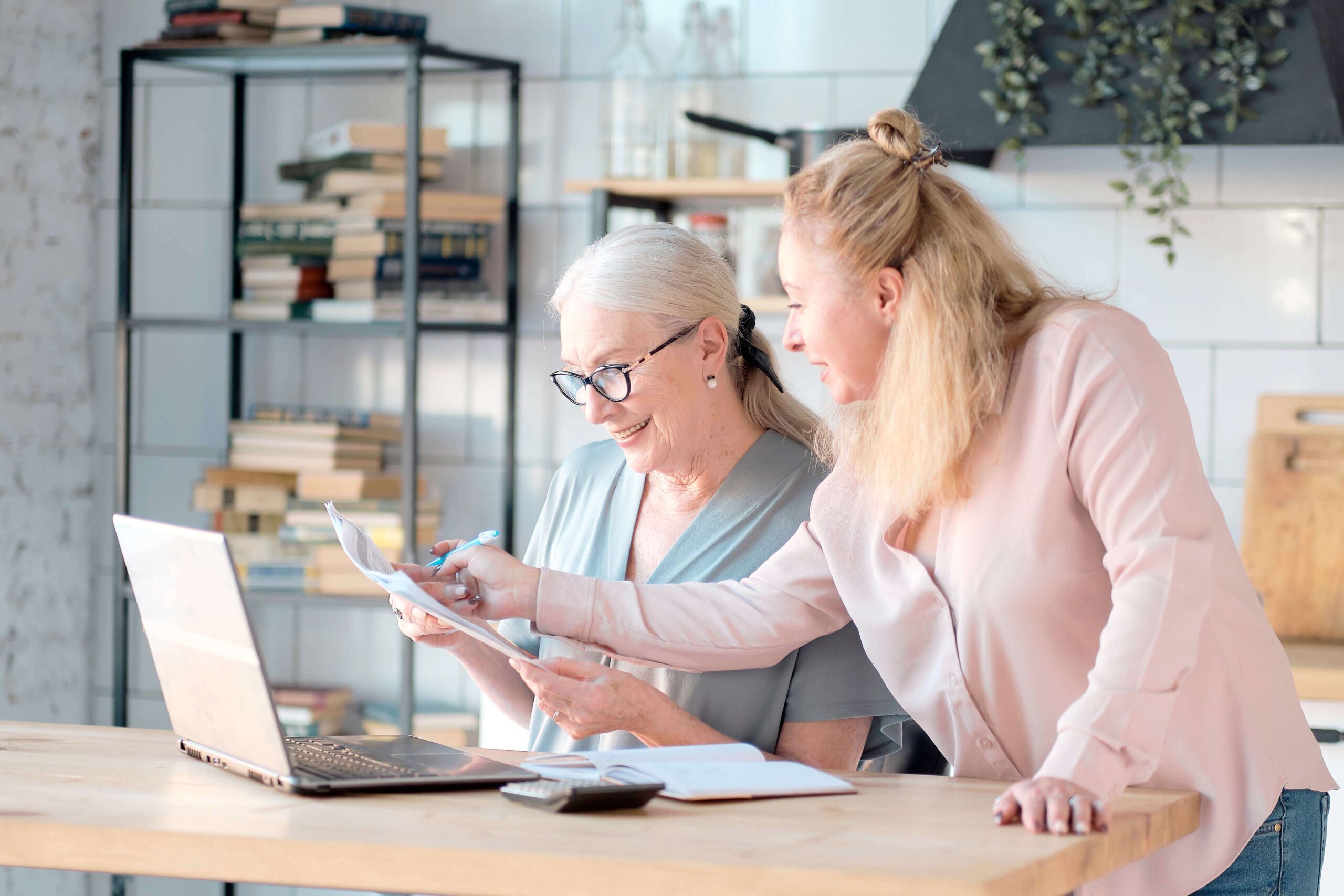 Older woman reviewing health insurance documents with a female insurance advisor